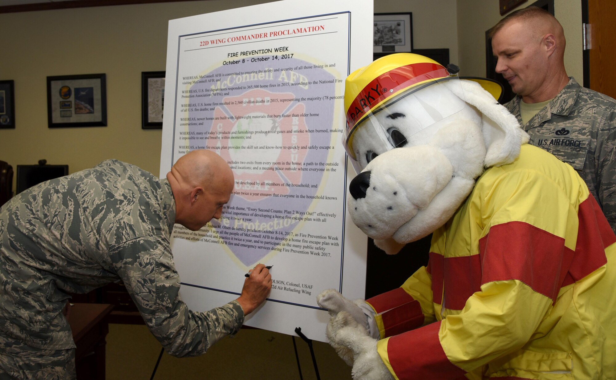 Col. Josh Olson, 22nd Air Refueling Wing commander, signs the fire prevention week proclamation Oct. 5, 2017, at McConnell Air Force Base, Kansas. This year’s theme ‘Every Second Counts: Plan 2 Ways Out!’ will help educate individuals to have more than one escape route while developing a home escape plan.