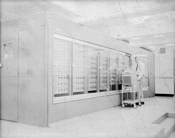 IMAGE: 09/23/1955
Man with monitor in front of NORC IBM Computer