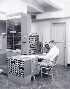 09/23/1955
Man at console in computer room