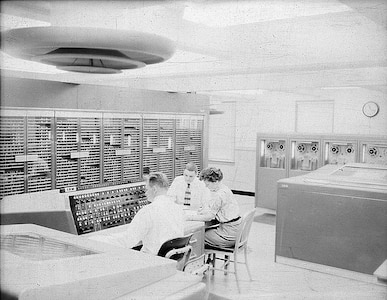 IMAGE: 09/23/1955
This view of the calculator shows an operator at the NORC console where he
can start and stop the calculator and guide its progress on a problem. The printer at his left prints
18,000 characters a minute recording the problems progress." NORC, IBM computer room.( with 3
personnel)