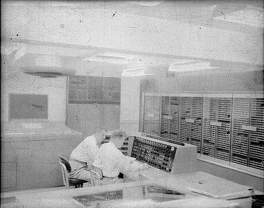 IMAGE: 09/23/1955
This view of the calculator shows an operator at the NORC console where he
can start and stop the calculator and guide its progress on a problem. The printer at his left prints
18,000 characters a minute recording the problems progress." NORC, IBM computer room.( with 2
personnel)