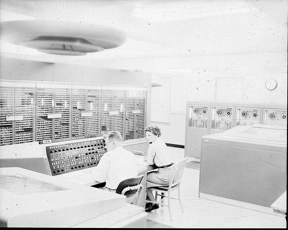 IMAGE: 09/23/1955
This view of the calculator shows an operator at the NORC console where he
can start and stop the calculator and guide its progress on a problem. The printer at his left prints
18,000 characters a minute recording the problems progress." NORC, IBM computer room.( with 2
personnel)