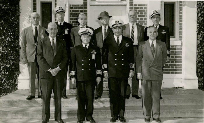 IMAGE: 11/20/1956
PERSONNEL HISTORY:   NPG Advisory Council with Rear-Admiral Stroop in front of Administration Building. Front Row L-R: Dr. J.H. Sachs, RADM P.O. Stroop, Capt. G.H. Wales, Dr. R.H. Lyddane.  Back Row L-R: Dr. LT.E. Thompson, Capt. E.B. Hooper, Dr. H.L Hazen, Dr. H.K. Ihrig, Dr. R. A. Sawyer, Capt. R. D. Risser.