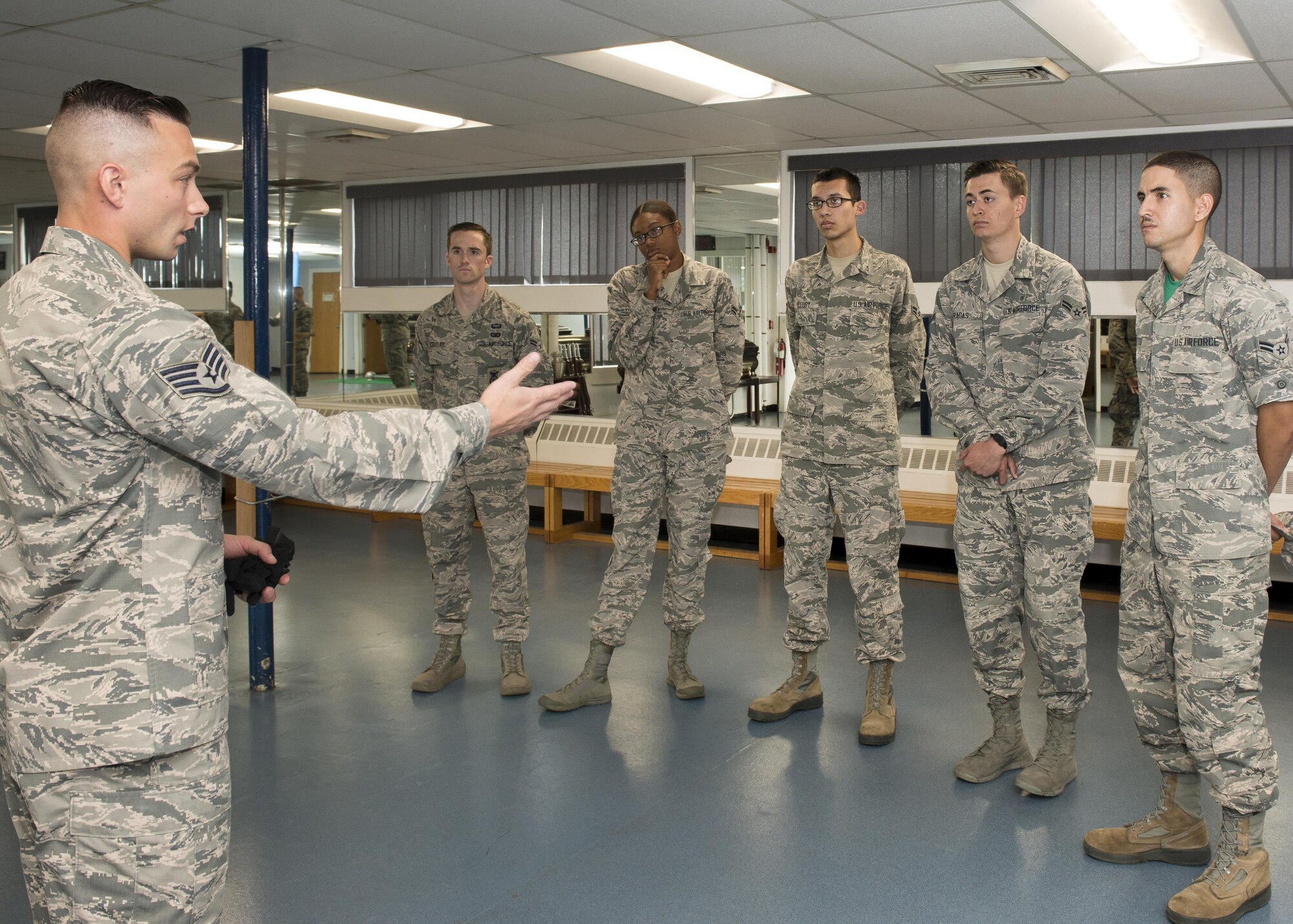 Staff Sgt. Meldion Shehu, a member of the Patriot Honor Guard team, speaks to Airmen participating in the First Term Airmen Center course during an Honor Guard facility tour Oct. 6.
