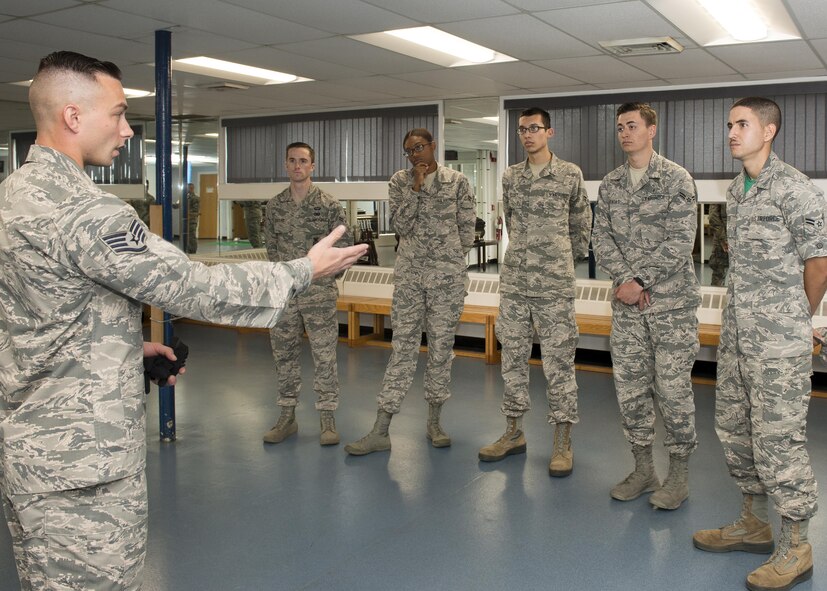 Staff Sgt. Meldion Shehu, a member of the Patriot Honor Guard team, speaks to Airmen participating in the First Term Airmen Center course during an Honor Guard facility tour Oct. 6.