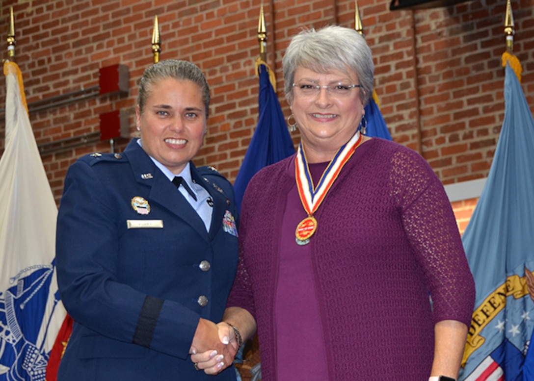 Defense Logistics Agency Aviation's Commander Air Force Brig. Gen. Linda Hurry inducted Carolynn Michel as the 35th Hall of Fame recipient during an awards ceremony Sept. 27, 2017 in the Frank B. Lotts Conference Center on Defense Supply Center Richmond, Virginia.