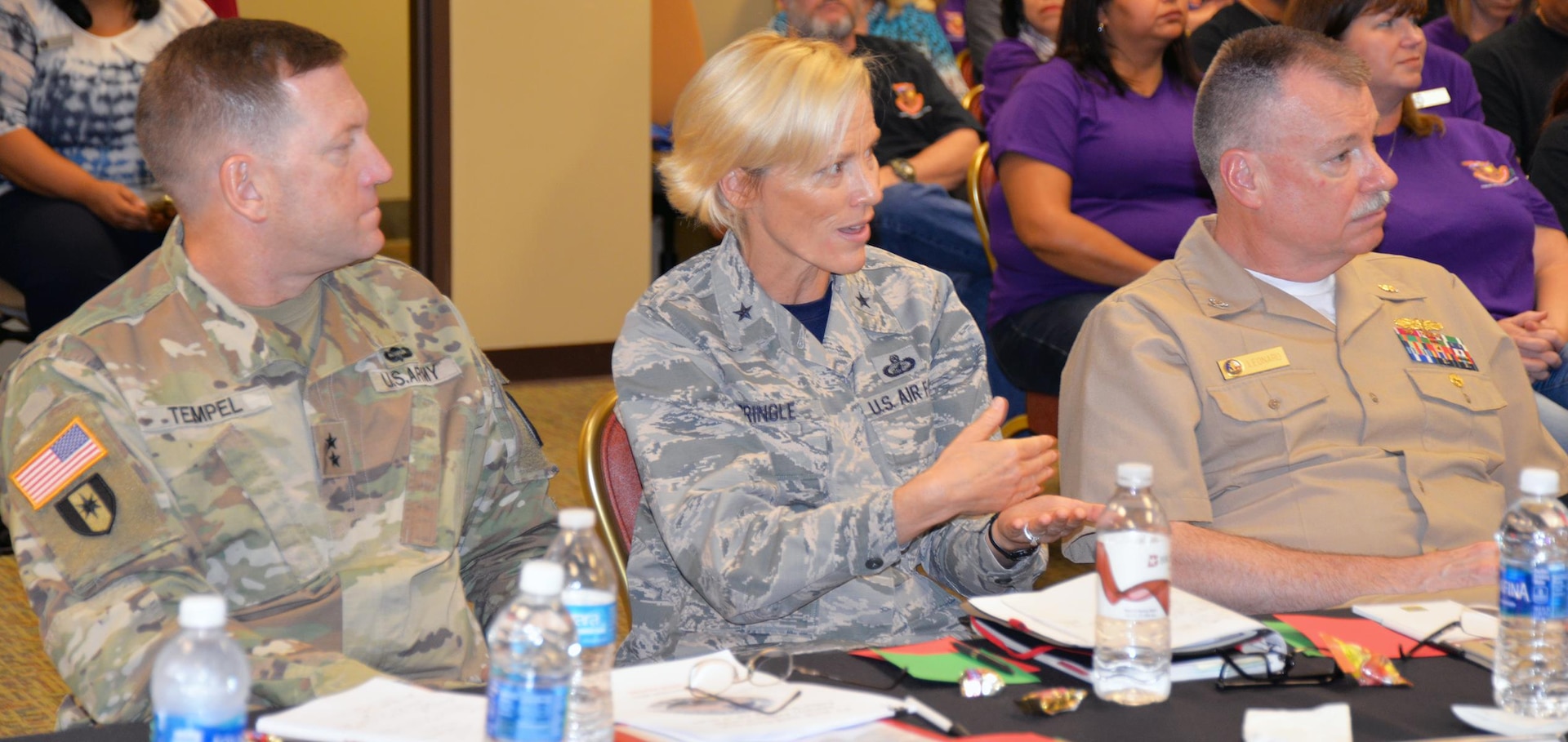 Brig. Gen. Heather Pringle (center), commander, 502nd Air Base Group and Joint Base San Antonio, asks a question of one of the members of a focus group at the report out session of the Armed Forces Action Program  annual forum, held at the Installation Management Command Academy Oct. 3-6. The general is flanked by Maj. Gen. Thomas Tempel (left), commander, Regional Health Command-Central; and Navy Capt. William Leonard (right), deputy commander, Navy Medicine Education and Training Command