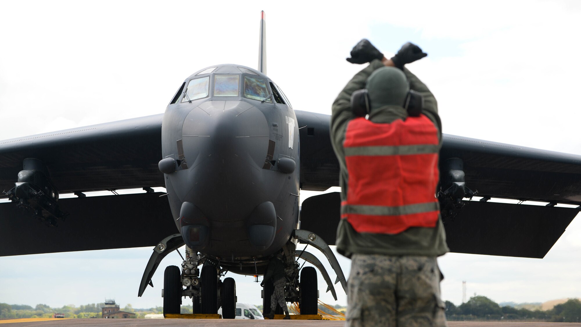 A B-52 Stratofortress is marshalled to a parking spot at Fairford Royal Air Force Base, U.K., Sept. 14, 2017.