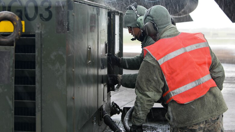 Airmen operate a power generator after marshalling a B-52 Stratofortress to a parking spot upon arrival at Fairford Royal Air Force Base, U.K., Sept. 14, 2017.