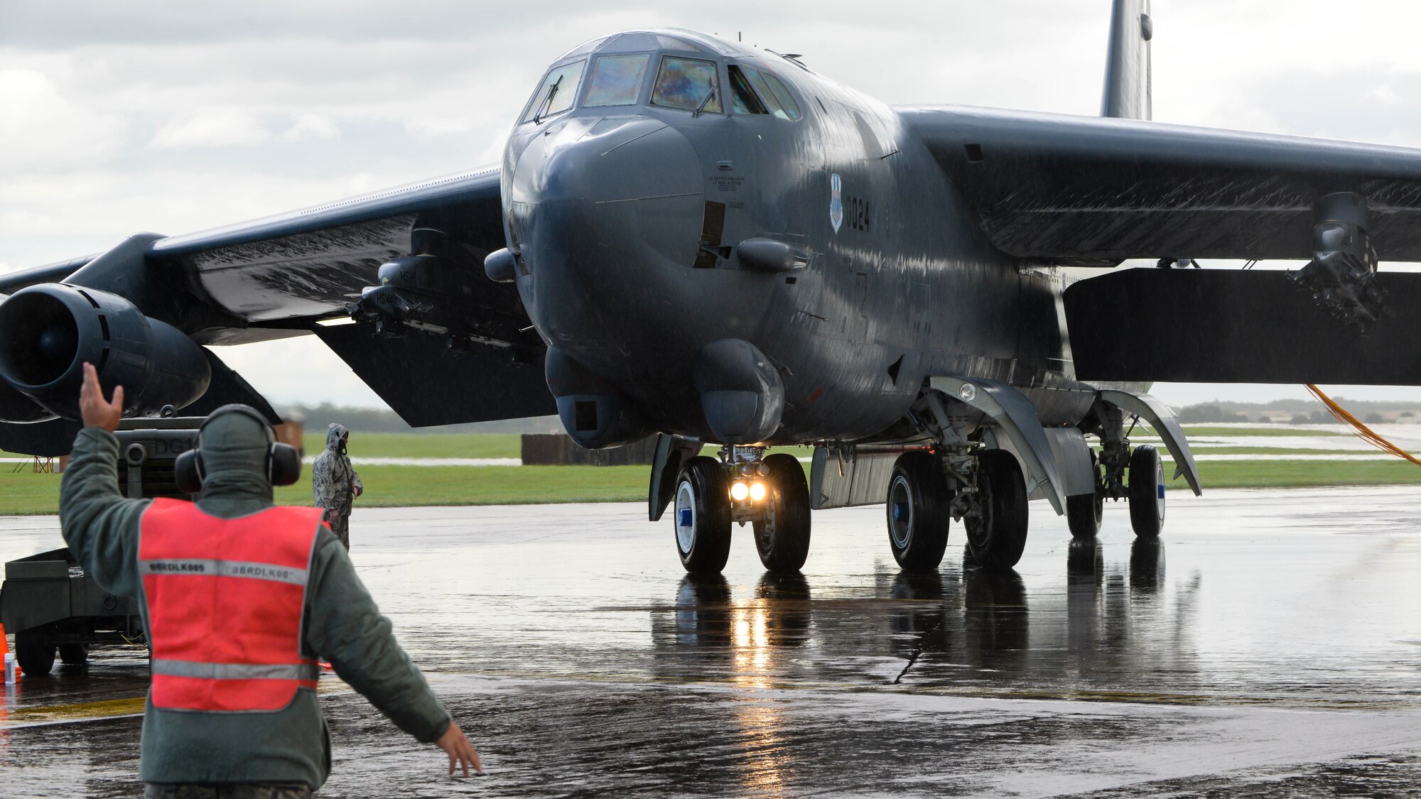 A B-52 Stratofortress is marshalled to a parking spot at Fairford Royal Air Force Base, U.K., Sept. 14, 2017.