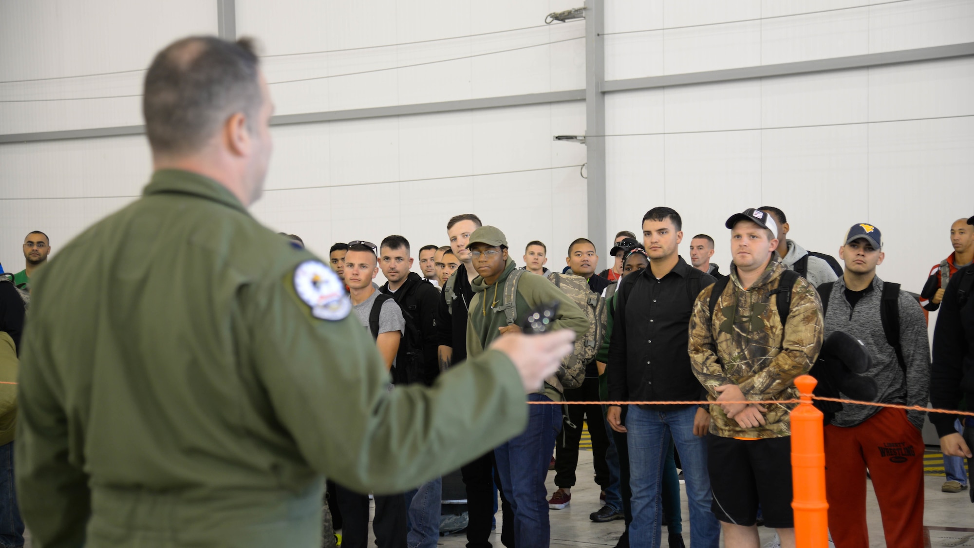 Airmen receive an arrival briefing before picking up their luggage at Fairford Royal Air Force Base, U.K., Sept. 11, 2017.