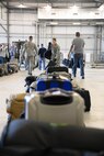Airmen pick up their luggage after their arrival to Fairford Royal Air Force Base, Sept. 11, 2017.