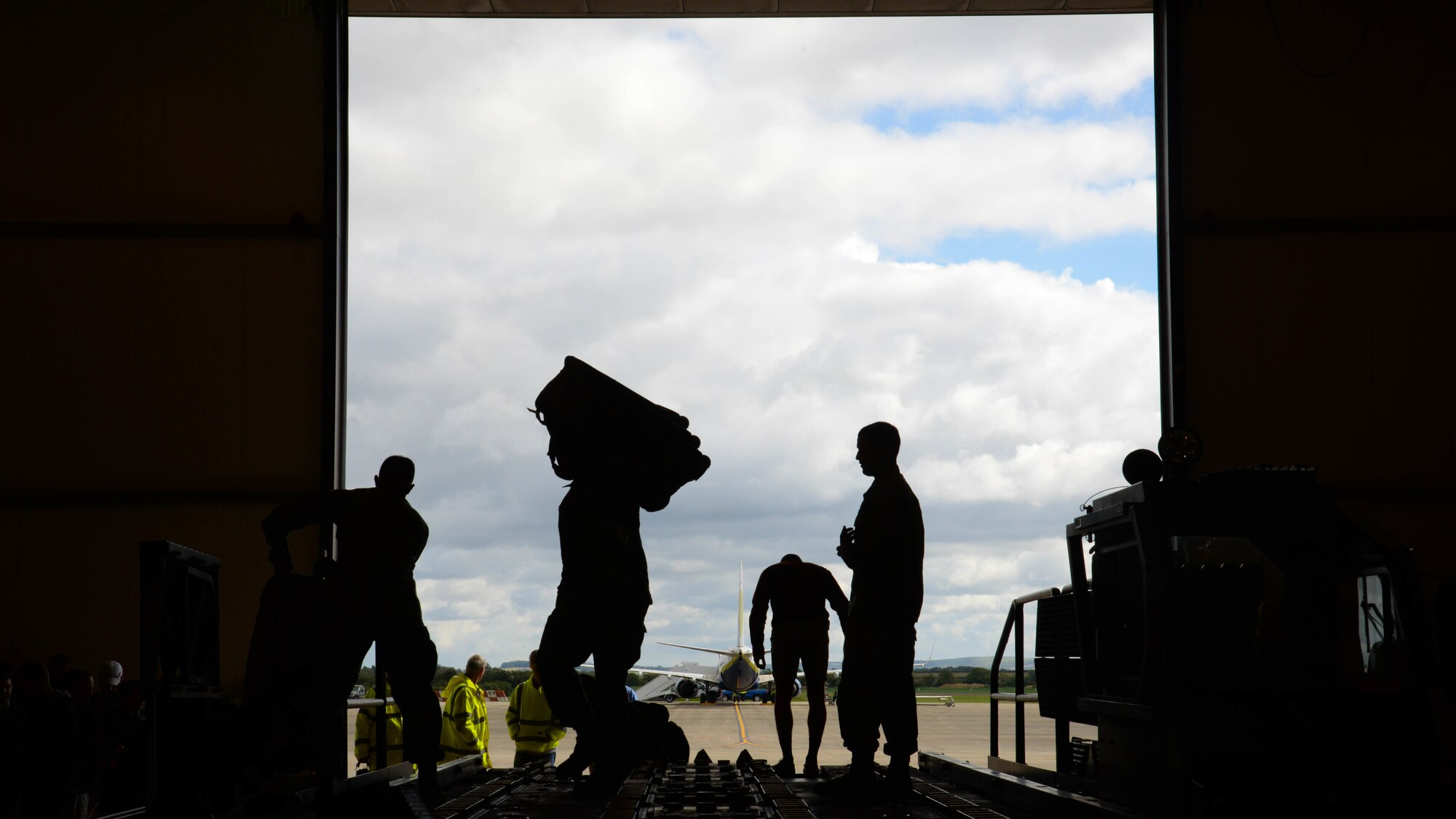 Airmen and volunteers help unload luggage from a truck after their arrival to Fairford Royal Air Force Base, Sept. 11, 2017.