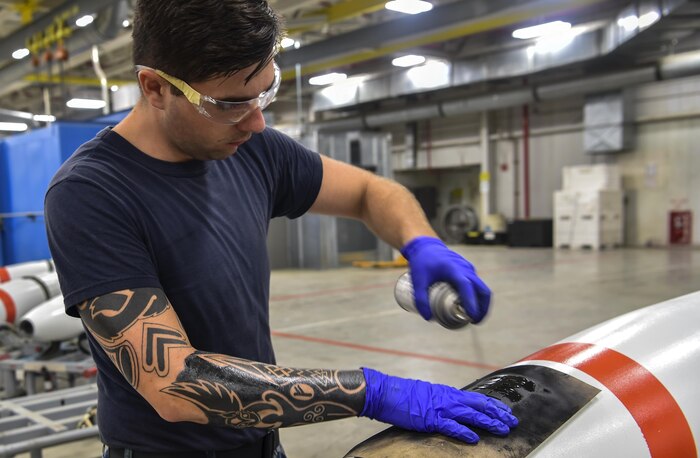 Mineman Seaman Dalton Sawyers, Navy Munitions Command Atlantic Unit Charleston, paints an identification marker on munitions at Joint Base Charleston – Naval Weapons Station, S.C., Aug. 29, 2017.