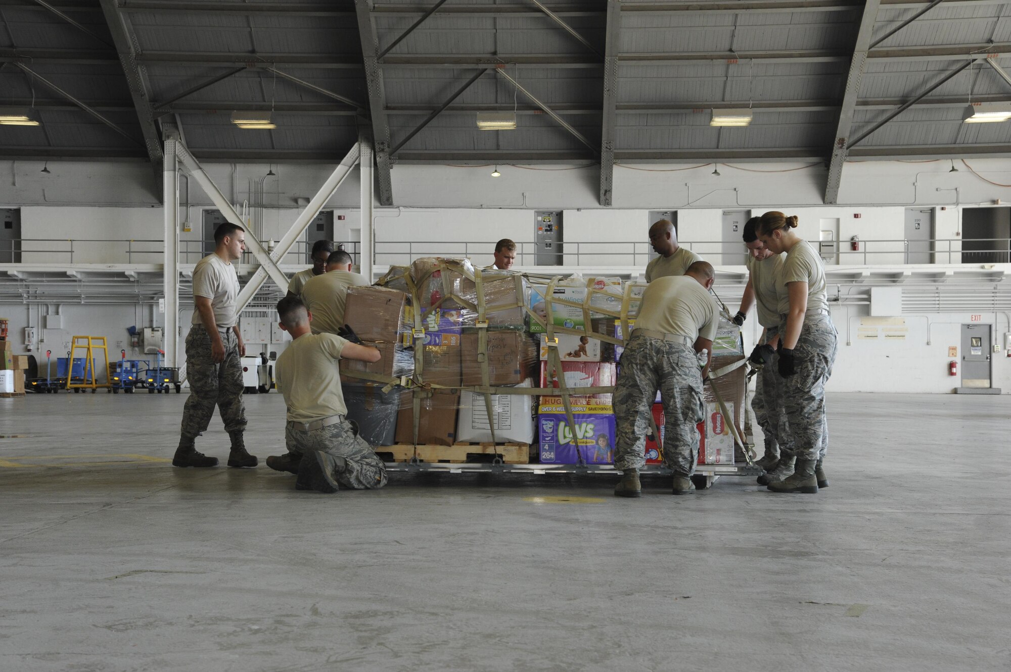 U.S. Air Force Airmen with the 6th Logistics Readiness Squadron (LRS) tighten straps on a pallet to be loaded onto a C-130 Hercules aircraft at MacDill Air Force Base, Fla., Oct. 4, 2017.