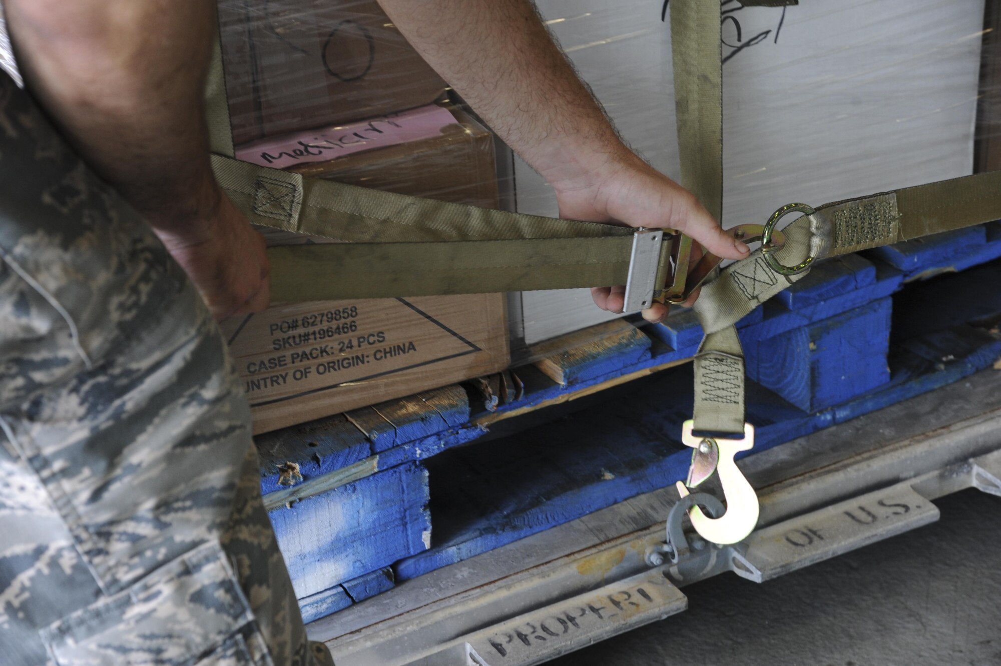 A U.S. Air Force Airman with the 6th Logistics Readiness Squadron (LRS) tightens straps on a pallet to be loaded onto a C-130 Hercules aircraft at MacDill Air Force Base, Fla., Oct. 4, 2017.
