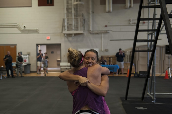 Carla Cimo congratulates Jamie Mechikoff after she completes the Alpha Warrior obstacle course during the Southeast Regional Alpha Warrior Competition at the Joint Base Charleston Air Base Gym Sept. 30, 2017.