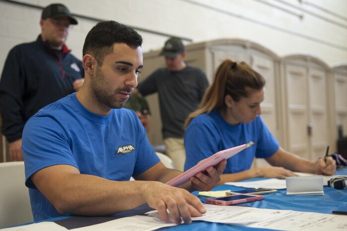 Shadi Zahed, Southeast Regional Alpha Warrior Competition lead official, tallies the final scores before announcing the winners following the Southeast Regional Alpha Warrior Competition in the Joint Base Charleston Air Base Gym Sept. 30, 2017.