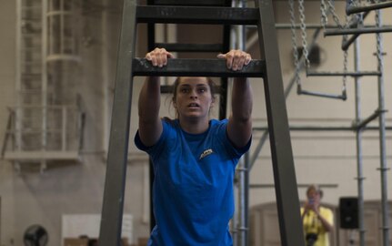 Lainie Long begins to ascend a ladder on the Alpha Warrior rig while competing in the Southeast Regional Alpha Warrior Competition at the Joint Base Charleston Air Base Gym Sept. 30, 2017.
