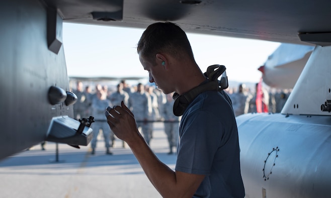 An Airman from the 57th Maintenance Group prepares a missile assembly on an F-16 Fighting Falcon, assigned to the 16th Weapons Squadron, during a load crew competition Oct. 6, 2017, at Nellis Air Force Base, Nev. Multiple squadrons participated in the competition which tested their speed and accuracy when loading munitions onto an aircraft. (U.S. photo by Airman 1st Class Andrew D. Sarver/Released)