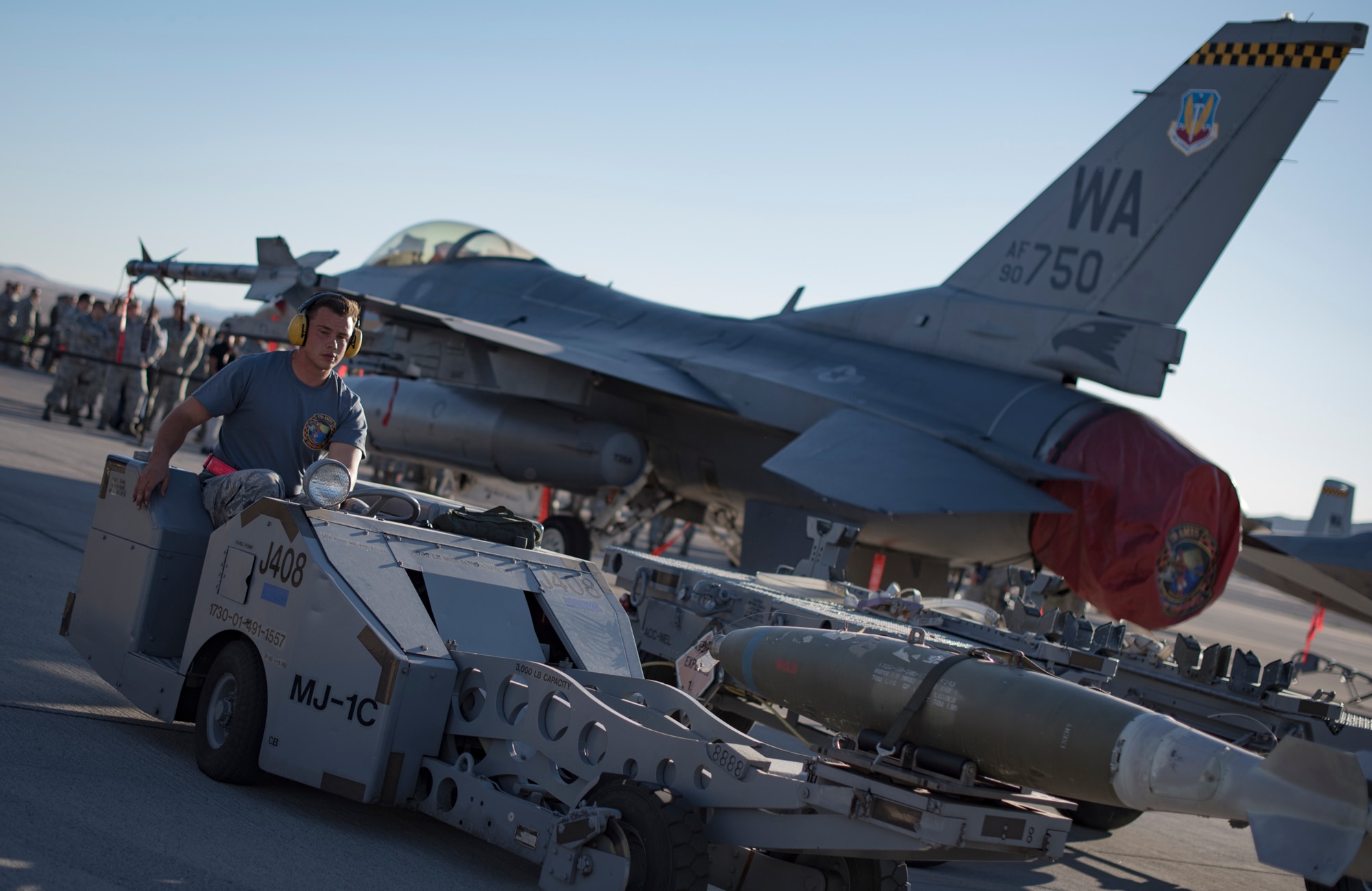 An Airman from the 57th Maintenance Group prepares a missile assembly on an F-16 Fighting Falcon, assigned to the 16th Weapons Squadron, during a load crew competition Oct. 6, 2017, at Nellis Air Force Base, Nev. Multiple squadrons participated in the competition which tested their speed and accuracy when loading munitions onto an aircraft. (U.S. photo by Airman 1st Class Andrew D. Sarver/Released)