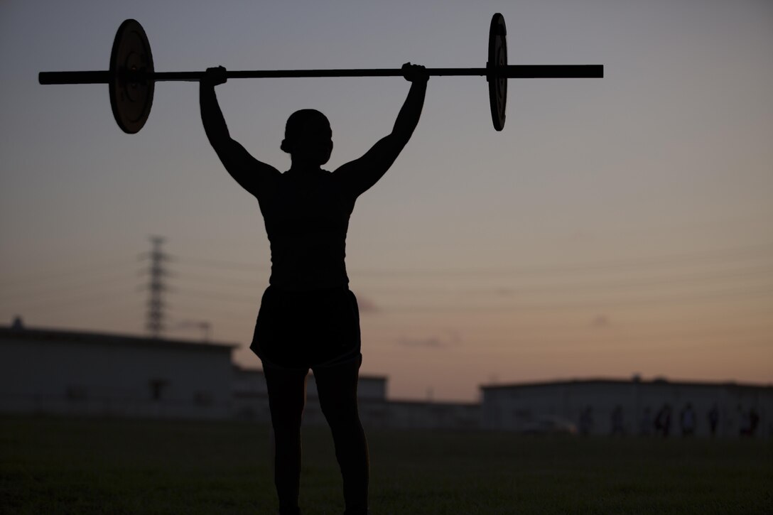 CAMP FOSTER, OKINAWA, Japan – Cpl. Jessica A. Anstett executes a clean and press Oct. 3 outside of Gunners Gym aboard Camp Foster, Okinawa, Japan. Anstett was selected as Marine of the Quarter for Headquarters and Support Battalion, her athletic background and dedication to her work set her miles apart from her peers. In August of 2017, her whole world was pulled out from under her in an instant when she tore her anterior cruciate ligament for the second time. With her surgery looming on the horizon, she plans to continue to work out, take college classes and volunteer. Anstett is a radio maintainer with H&S Bn., Marine Corps Installations Pacific-Marine Corps Base Camp Butler, Japan. (U.S Marine photo by Lance Corporal Tayler P. Schwamb)