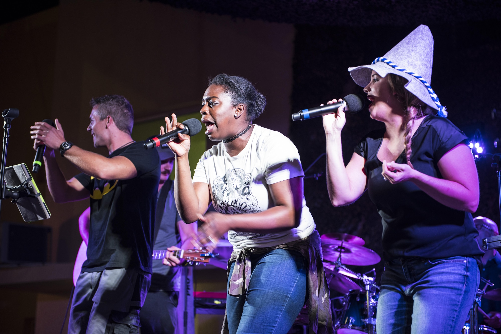 Vocalists from the U.S. Air Force Central Command band join other Coalition service member musicians on stage for a rendition of, “Sweet Home Alabama,” during an Oktoberfest celebration Sept. 24, 2017, in Southwest Asia. The USAFCENT band, Touch N’ Go, travels to a number of installations in support of Operation Inherent Resolve. (U.S. Air Force photo by Senior Airman Joshua Kleinholz)