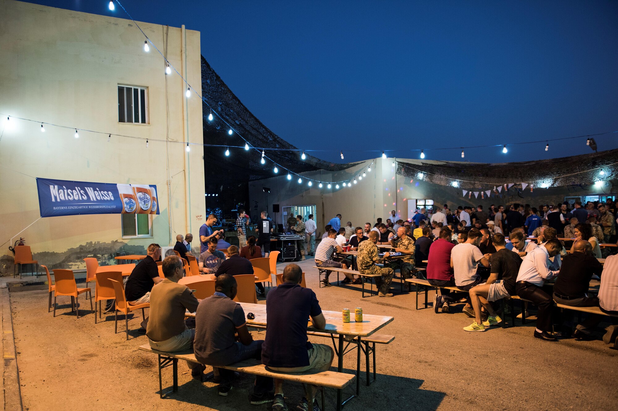 Coalition service members come together for an Oktoberfest celebration Sept. 24, 2017, in Southwest Asia. Originating from the world-famous Bavarian folk festival held annually in Munich, Germany, revelers across the world plan their own adaptations of the event from late September through early October. (U.S. Air Force photo by Senior Airman Joshua Kleinholz)