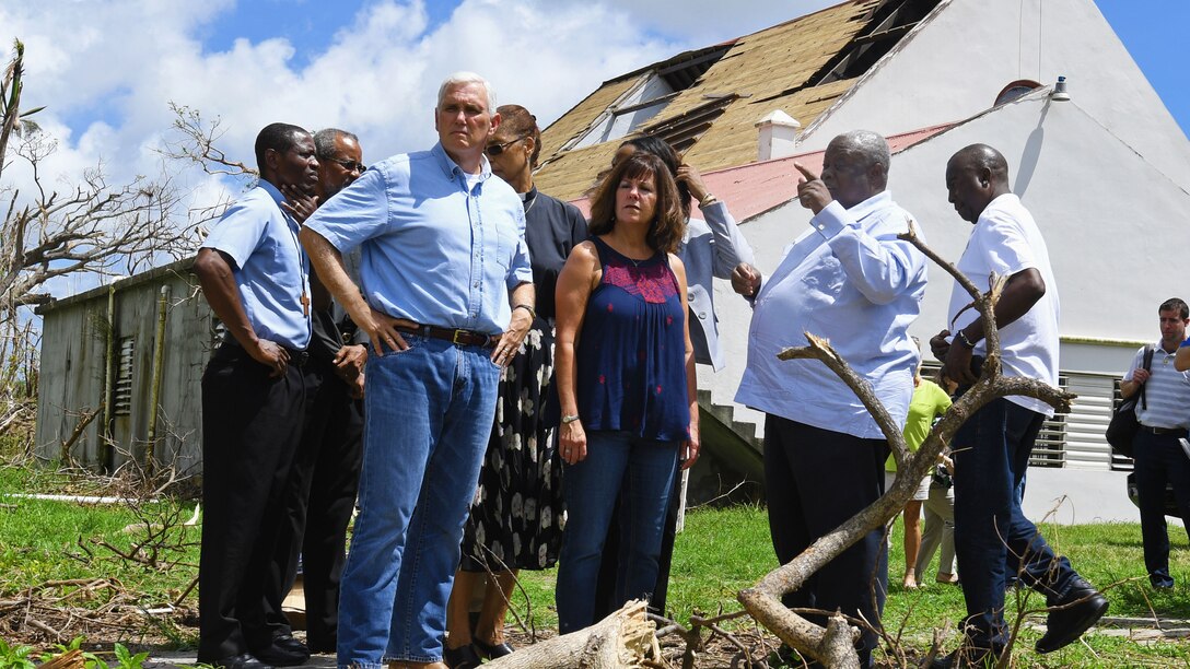 Vice President Mike Pence surveys damage with a group of local leaders.