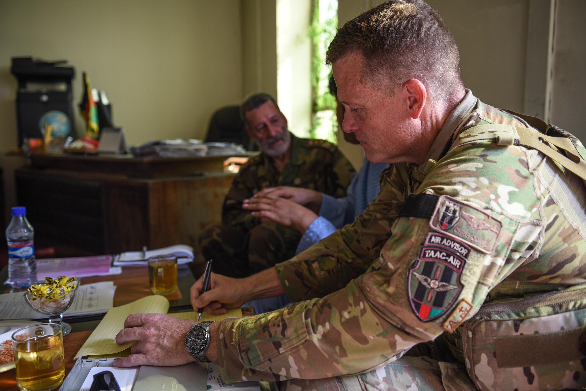 Chaplain (Maj.) Chris Conklin, Train, Advise, Assist Command-Air air advisor (right), takes notes during a meeting with Afghan National Army Col. Abdul Basir, head of the Afghan Air Force Religious and Cultural Affairs office, Sept. 14, 2017, in Kabul, Afghanistan. Conklin provides coordination and advice on the organization of religious support in the developing Afghan Air Force. (U.S. Air Force photo by Staff Sgt. Alexander W. Riedel)