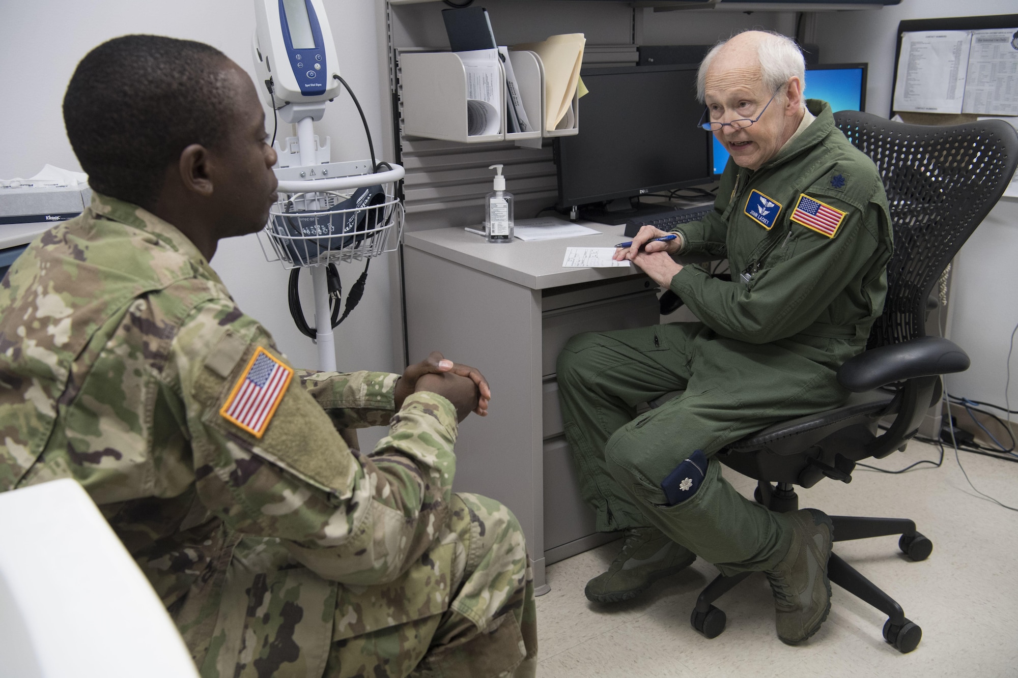 Lt. Col. John Lackey meets with a patient.