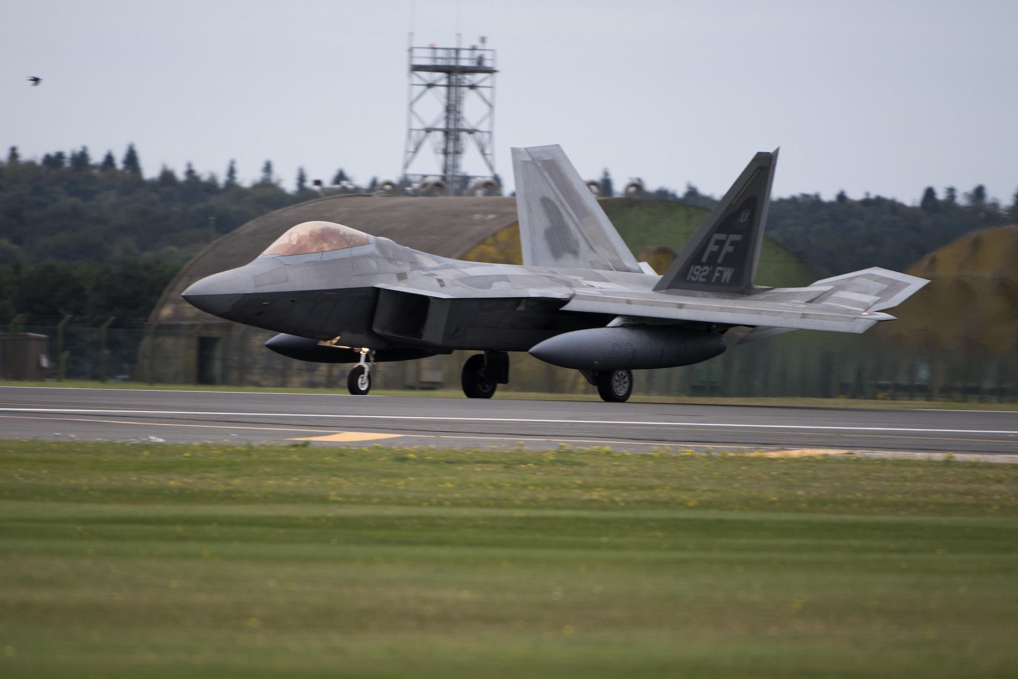 An F-22 Raptor from the 1st Fighter Wing, Joint Base Langley-Eustis, Virginia arrives at Royal Air Force Lakenheath, England Oct. 8, 2017. This flying training deployment is an opportunity for the F-22s to fly alongside Europe-based U.S. and allied air force aircraft in a realistic training environment. (U.S. Air Force photo/Senior Airman Malcolm Mayfield)