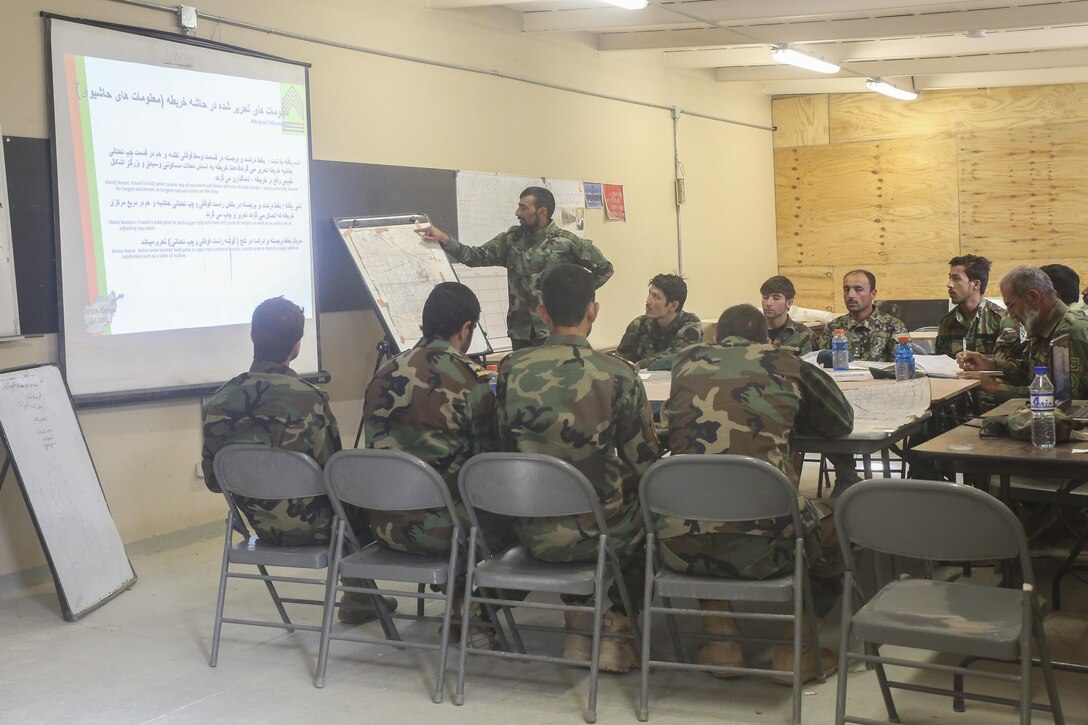 An Afghan National Army instructor with the Helmand Regional Military Training Center teaches officers with 6th Kandak, 1st Brigade, 215th Corps land navigation techniques at Camp Shorabak, Afghanistan, Oct. 7, 2017. U.S. Marine advisors with Task Force Southwest are supporting their Afghan counterparts throughout an eight-week operational readiness cycle. The ANA-led training regimen is developing the infantry skills of 6th Kandak, 1st Brigade through classroom instruction, practical application and live-fire exercises. (U.S. Marine Corps photo by Sgt. Lucas Hopkins)