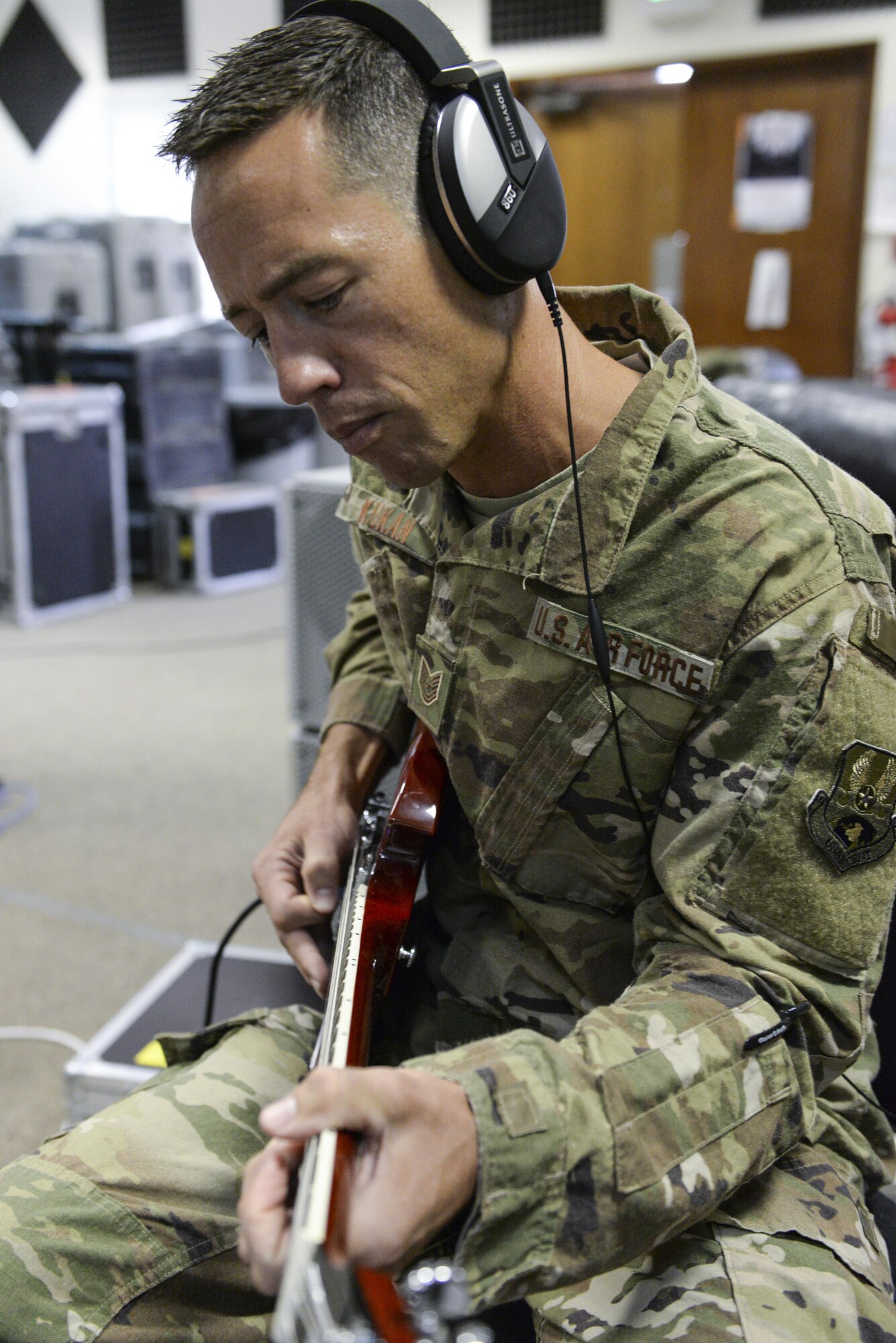 U.S. Air Force Tech. Sgt. John Kukan, non-commissioned officer in charge and guitar player assigned to the Air Force Central Command Band, Touch-n-Go, plays during a recording session as the band recorded their punk rock rendition of the Air Force Song at Al Udeid, Air Force Base, Qatar, Sept. 21, 2017.