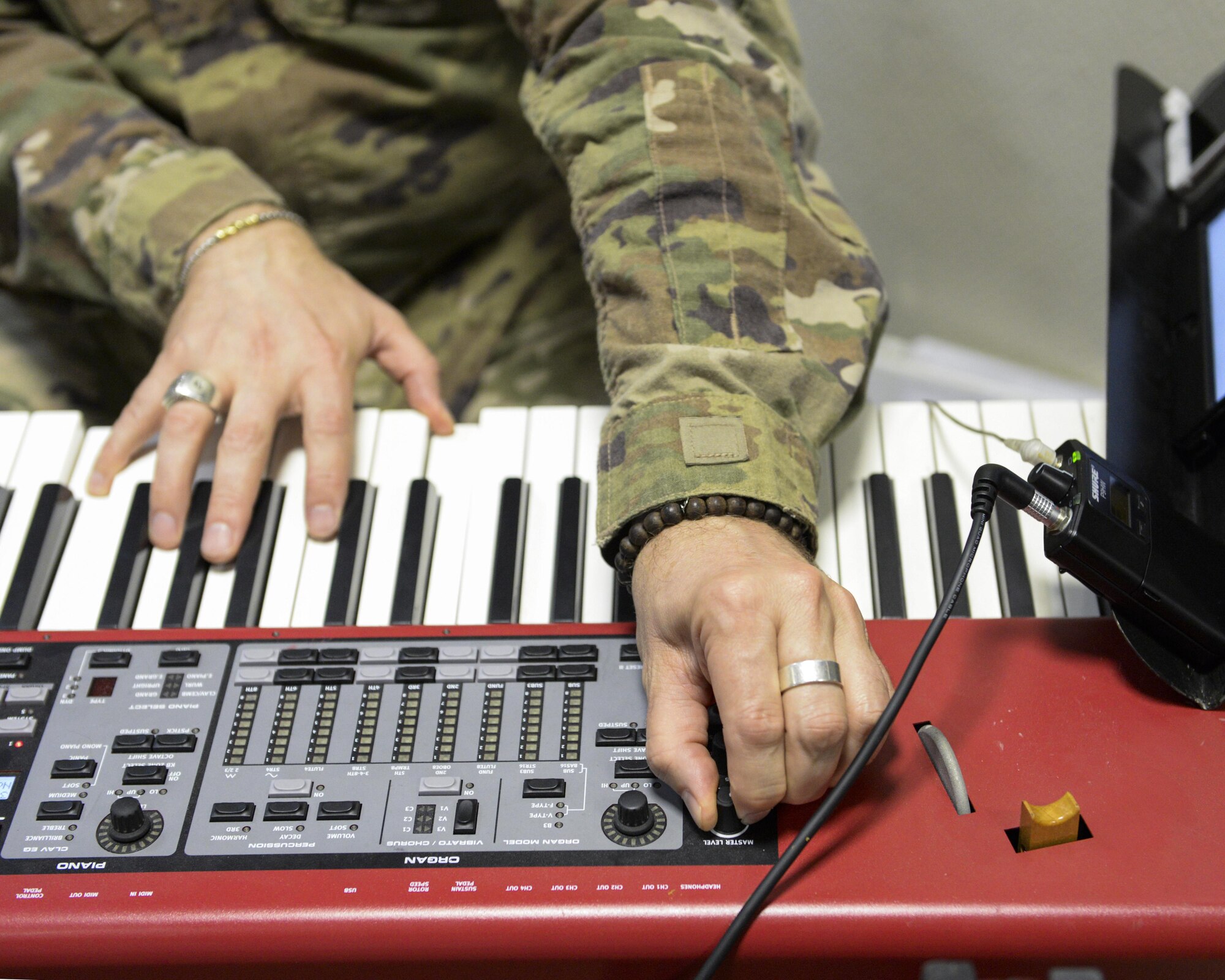 U.S. Air Force Staff Sgt. Robert Barnes, keyboardist assigned to the Air Force Central Command Band, Touch-n-Go, plays keyboard during a recording session as the band recorded their punk rock rendition of the Air Force Song at Al Udeid, Air Force Base, Qatar, Sept. 21, 2017.