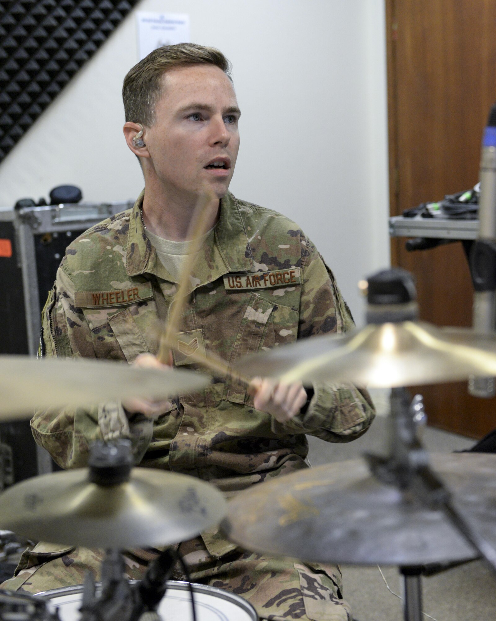 U.S. Air Force Staff Sgt. Mark Wheeler, drummer assigned to the Air Force Central Command Band, Touch-n-Go, plays drums during a recording session as the band recorded their punk rock rendition of the Air Force Song at Al Udeid, Air Force Base, Qatar, Sept. 21, 2017.