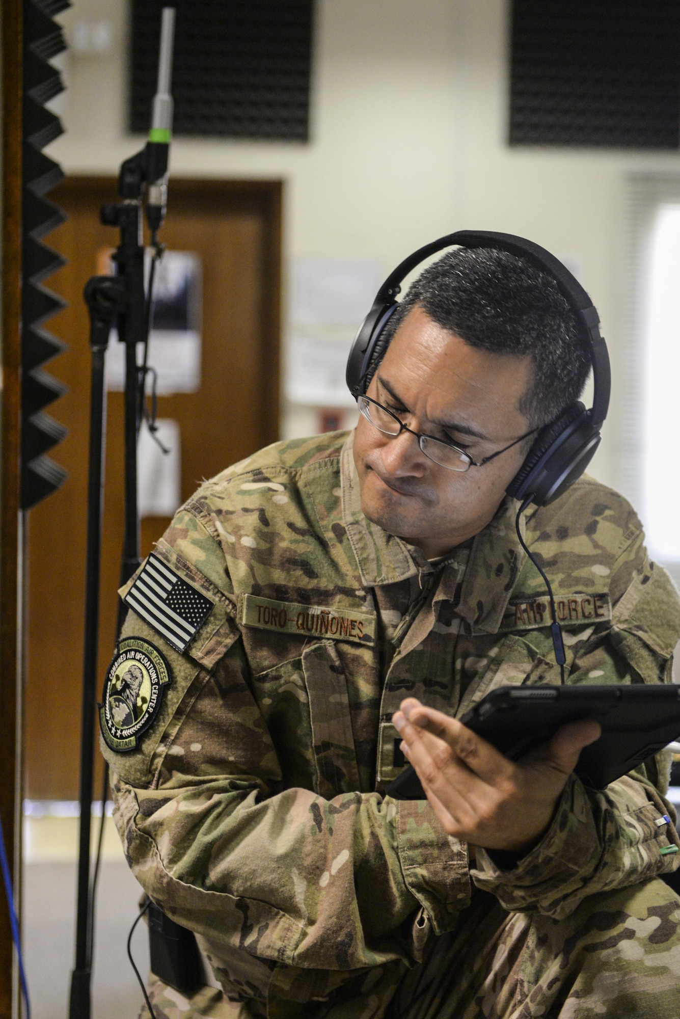 U.S. Air Force Capt. Rafael Toro-Quinones, officer in charge assigned to the Air Force Central Command Band, Touch-n-Go, listens to the band during a recording session where the band recorded their punk rock rendition of the Air Force Song at Al Udeid, Air Force Base, Qatar, Sept. 21, 2017.