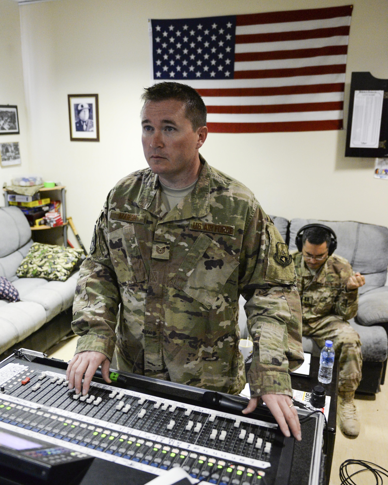U.S. Air Force Tech. Sgt. John Marsh, audio engineer assigned to the Air Force Central Command Band, Touch-n-Go, adjusts sound levels during a recording session as the band recorded their punk rock rendition of the Air Force Song at Al Udeid, Air Force Base, Qatar, Sept. 21, 2017.