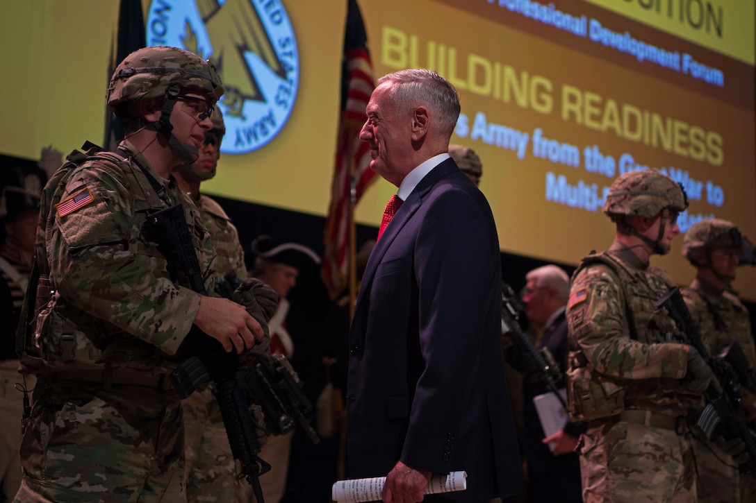 Defense Secretary Jim Mattis speaks with soldiers on stage.