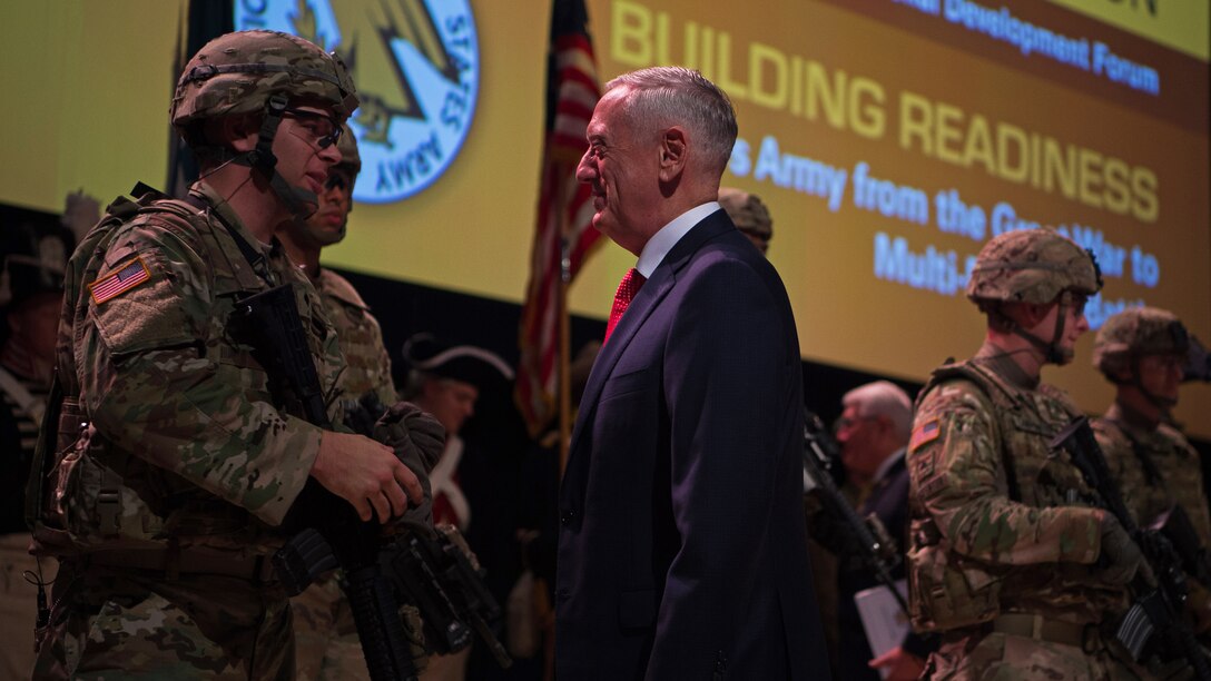 Defense Secretary Jim Mattis speaks with soldiers on stage.