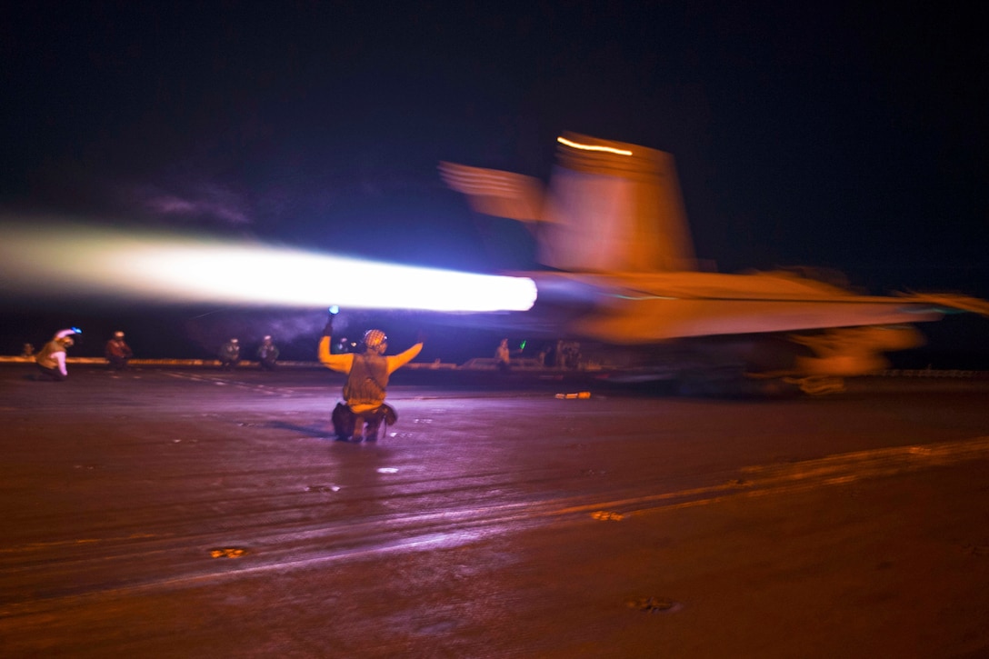 An F/A-18F Super Hornet launches from the flight deck of the aircraft carrier USS Nimitz.