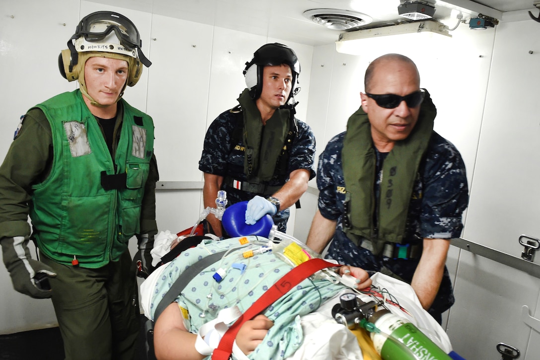 Sailors transport a patient from Menonita Hospital in Caguas, Puerto Rico, aboard the hospital ship USNS Comfort.
