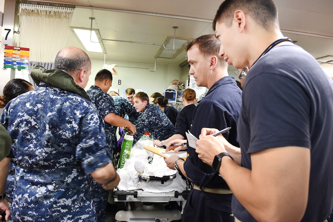 Sailors treat a patient from Menonita Hospital in Caguas, Puerto Rico after arriving on board the hospital ship USNS Comfort.