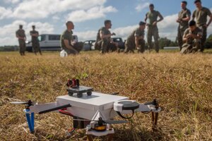 A small unmanned aerial system sits on the ground.