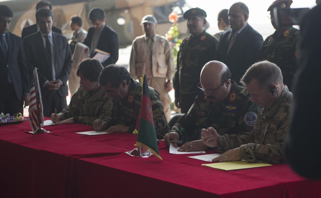 U.S. and Afghan military leaders sign certificates officially transferring the UH-60 Black Hawk helicopters from the U.S. military to the Afghan Air Force during a ceremony Oct. 7, 2017, at Kandahar Airfield, Afghanistan. The AAF received Black Hawks from the U.S. to bolster their air power capabilities. The helicopters provide sustainable, capable replacements for aging aircraft currently in use. (U.S. Air Force photo by Staff Sgt. Benjamin Gonsier)