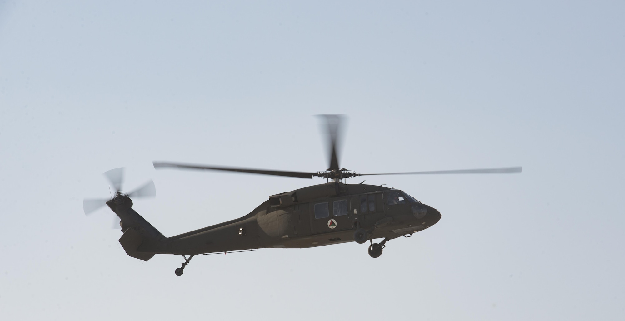 An Afghan Air Force UH-60 Black Hawk helicopter hovers over Kandahar Airfield, Afghanistan, Oct. 7, 2017. The AAF received the first two Black Hawks from the U.S. to bolster their air operations capabilities. The helicopters provide sustainable, capable replacements for aircraft currently in use. The UH-60s will help the AAF and Afghan National Defense and Security Forces combat insurgent groups. (U.S. Air Force photo by Staff Sgt. Benjamin Gonsier)