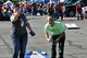 Air Force Reserve 910th Airlift Wing Director of Psychological Health Terri Ann Naughton, shows off her skills as Staff Sgt. Nicholas Bacisin, a military personnel technician assigned to the 910th Force Support Squadron, reacts during a cornhole match at a 910th Airlift Wing tailgate picnic here, Sept. 30, 2017.