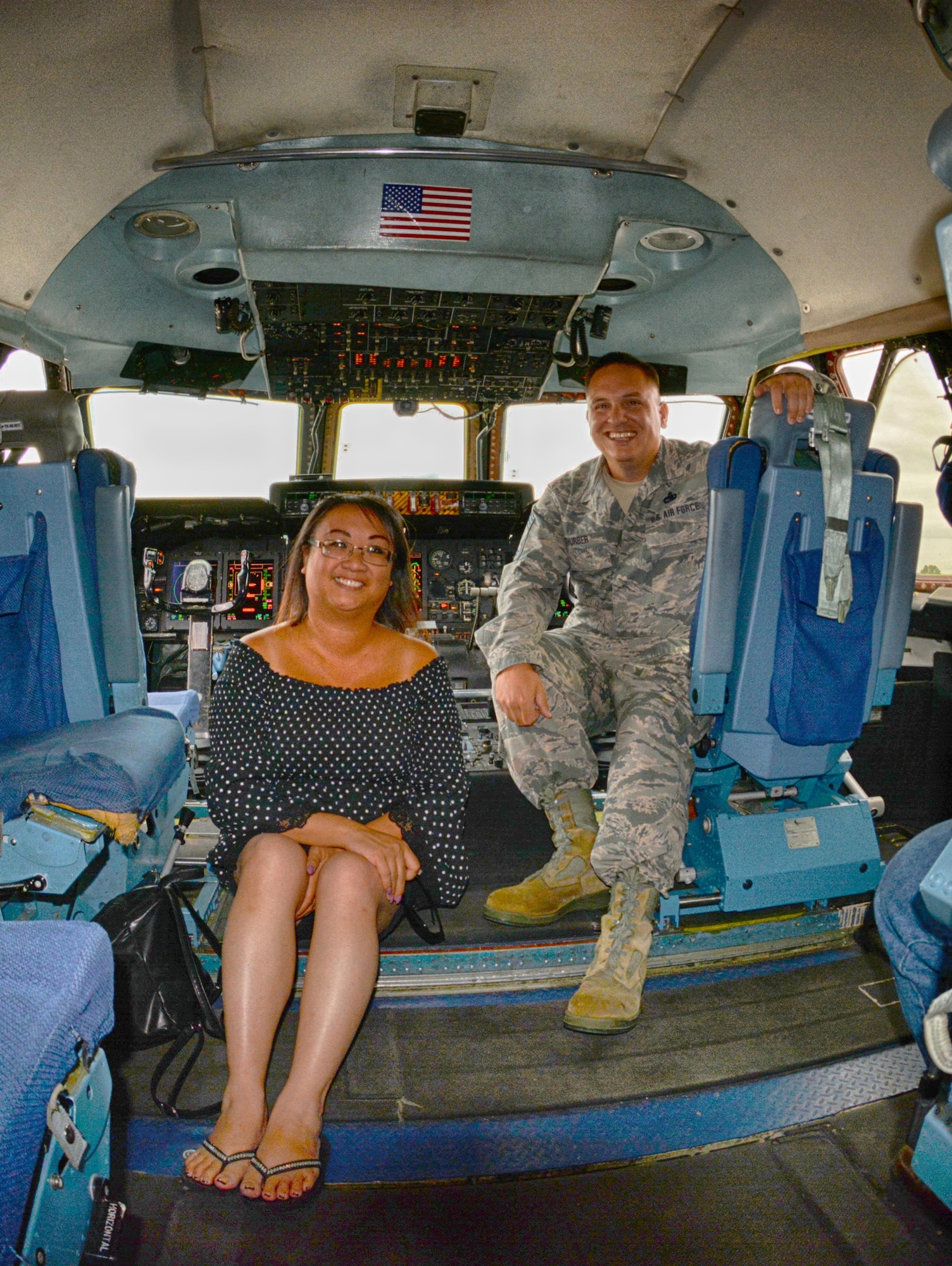 Karen Keshura, Babylift crash survivior, poses for a photo with Chief Master Sgt. Justin Thurber in the cockpit of C-5A Galaxy 0461, the Air Force's final C-5A that recently was retired.