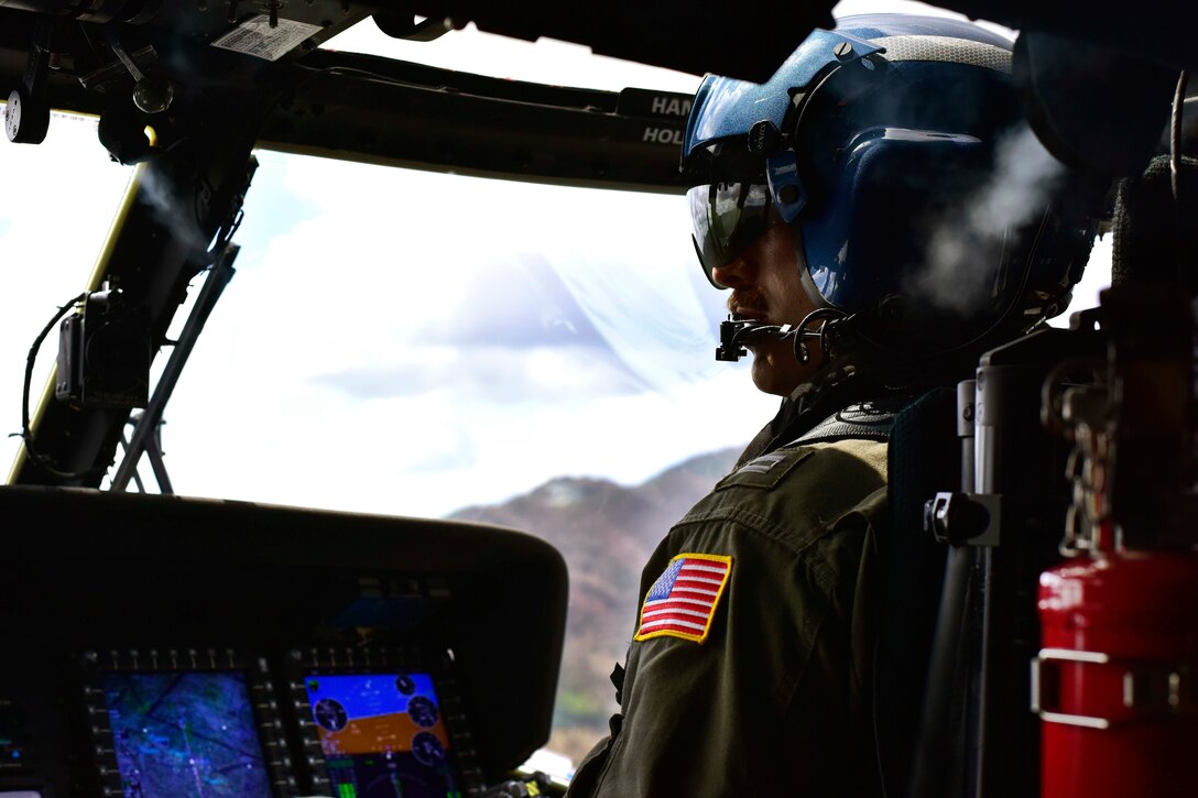 Coast Guard Lt. Paul Junghans flies a Coast Guard MH-60 Jayhawk helicopter towards Maricao.