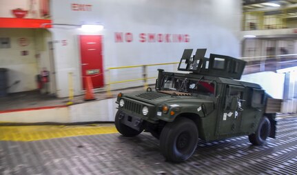 A Humvee is driven onto a ship during an on-load at Joint Base Charleston-Weapons Station, S.C., Sept. 27, 2017.
